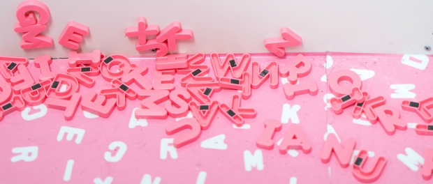 pink letters fall from the fridge to the floor