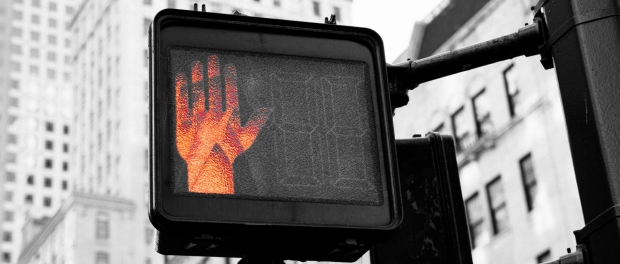 Red hand on city crosswalk sign